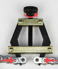 Roller chain breaker tool with adjustable screw, black frame and visible bicycle chain links