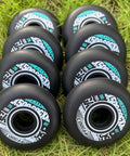 Inline Skate Wheels 4 Pack For Outdoor Indoor Use 78mm 80mm 85A with Bearings on grass in neat rows