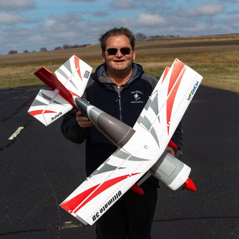 Man holding Ultimate 3D 950mm RC Airplane With AS3X Safe Technology Smart BNF Basic Ready To Fly for aerobatics