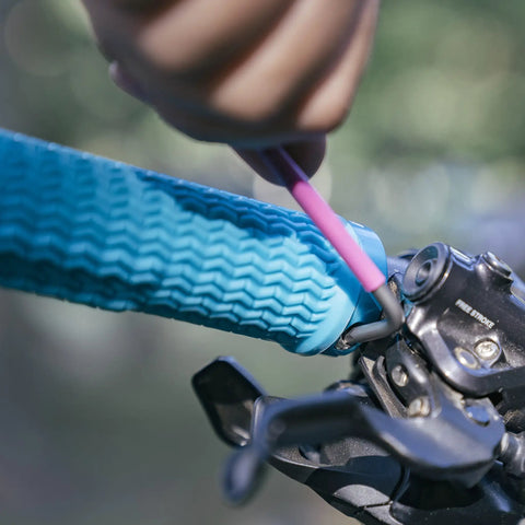 Close-up of installing blue lock-on mountain bike grips with 22mm inner diameter, ergonomic handles for MTB and BMX.
