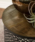 Premium Drum Base Accent Table Featuring A Perforated Quatrefoil Metal Lattice And Rich Mango Wood Top A Real Flex For Your Everyday Cozy Hangout Space with a decorative plant on top.