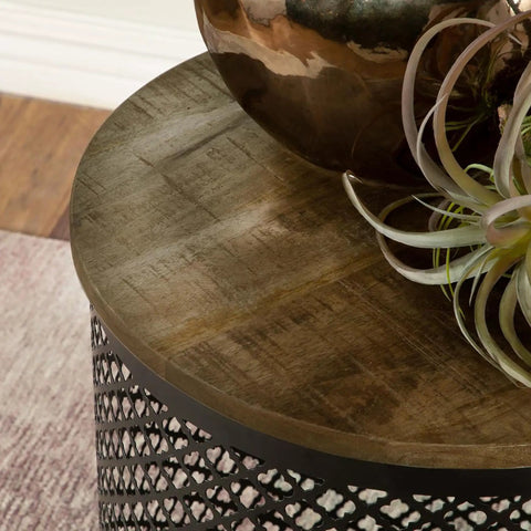 Premium Drum Base Accent Table Featuring A Perforated Quatrefoil Metal Lattice And Rich Mango Wood Top A Real Flex For Your Everyday Cozy Hangout Space with a decorative plant on top.