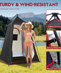 Camping Shower Tent For Privacy On The Go with woman in swimsuit by lake, showing stable structure and metal poles.