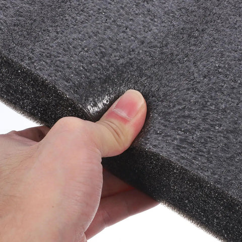 Close-up of a hand testing the tear resistance of Heavy Duty Black Epe Foam Boards Pack Of 4 Multi Use Foam Inserts for shipping.