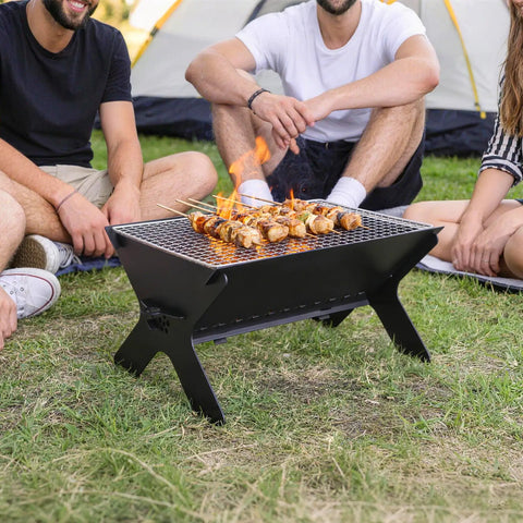Outdoor scene with Portable Campfire Grill For Outdoors Large Folding Stainless Steel Fire Pit With Grill And Carry Bag Heavy Duty Charcoal BBQ.