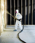 Worker in Disposable Protective Coverall With Elastic Cuffs, Attached Hood And Boots, White, Large, spraying foam
