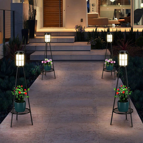 2 Pack Outdoor Solar Lights With Plant Stand And Tall Metal Planter Holder illuminating a patio pathway at night