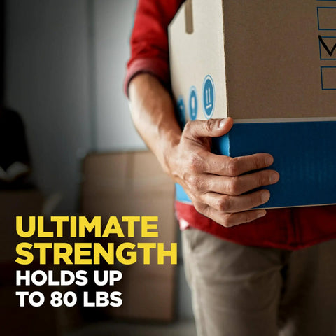 Person lifting box sealed with Heavy Duty Packing Tape 2 Inch Wide By 800 Inch Long Clear Two Roll Pack With Dispenser Sticks Like Glue