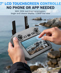 5.7" LCD touchscreen controller for drone operation, user adjusting settings, scenic coastal view, no phone needed.