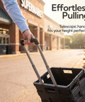 Person pulling a Heavy-Duty Rolling Utility Cart With Collapsible Crate outside a supermarket, highlighting the telescopic handle.