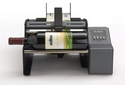 Hustle Ready Semi Automatic Label Applicator for Cylindrical Bottles, showing wine bottle with label, efficient setup for production.