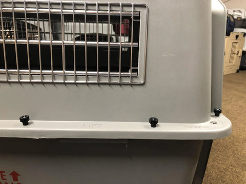Beefed Up Pet Carrier Bolt Fasteners Kit With Twenty Steel Carriage Bolts And Twenty Black Plastic Wing Nuts For Dog Kennels shown attached to a pet carrier