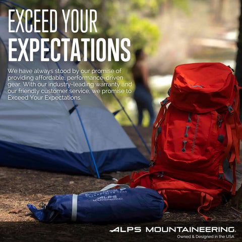 Orange backpack and blue tent bag near camping tent in forest setting.