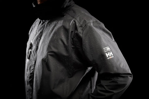 Close-up of black Men's Waterproof Shell Jacket With Detachable Hood And High Collar, Breathable Fully Taped Seams, no shoulder seams.