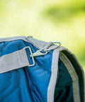 Close-up of Western Padded Saddle Carrier with Water Resistant 420D Nylon showing metal clip and turquoise fabric detail.