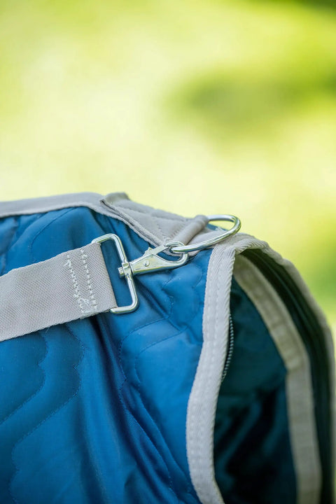 Close-up of Western Padded Saddle Carrier with Water Resistant 420D Nylon showing metal clip and turquoise fabric detail.