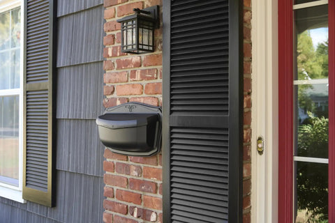 Black Wall Mount Mailbox Crafted From Die Cast Aluminum With Powder Coat installed on brick wall beside front door