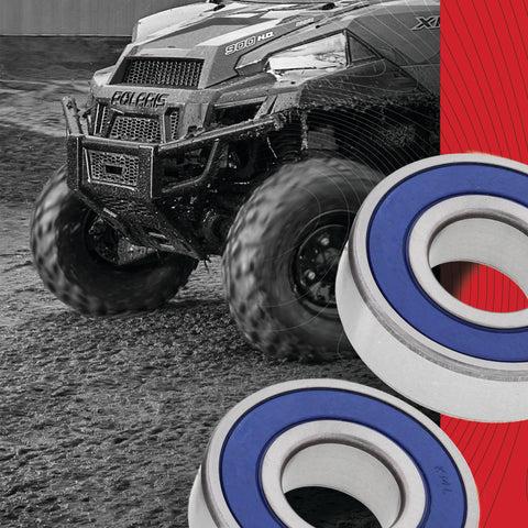Wheel Bearing Kit For Honda Replacement With 2 ABEC 3 High Speed Bearings And Rubber Sealed Seals Type TC Double Chevron SR1 2 Grease For Beefed Up Rust And Dirt Protection, depicted near an all-terrain vehicle