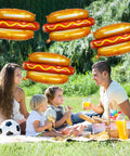 Family picnic with 7 Pack 28 Inch Hot Dog Balloons Foil Mylar Helium Balloons For BBQ Picnic Birthday Carnival Cookout Food Theme Party Decorations Durable Thickened Aluminum Foil Reusable Giant Food Themed Party Decor in the background.