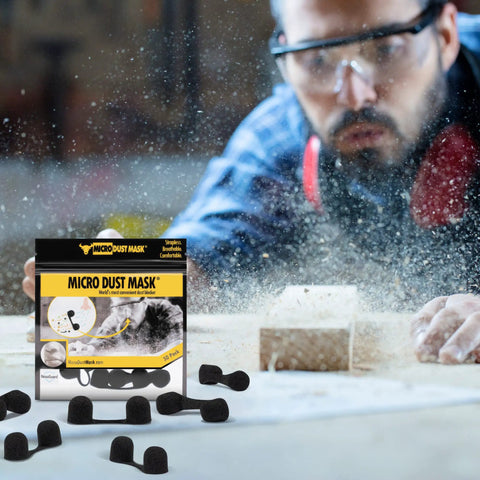 Man woodworking with dust visible, using Dust Blocking Nose Filter Mask For Nose Breathable Disposable Protective Mask For Woodworking Lawn Mowing And Light Construction Nasal Filter With Comfortable No Pinch Fit And Secure Nose Piece 30 Pack.