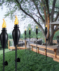 Six Pack 59 Inch Outdoor Tiki Torches for Patio and Garden with Citronella, Metal Torch with Durable Fiberglass Wick in backyard.