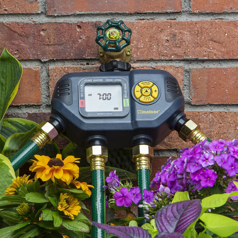 Four Zone Digital Water Timer With Flexible Scheduling From Every Hour To Once A Week Manual Override No Fuss Setup shown in a garden
