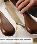 Six Pack Wide Shoulder Walnut Wooden Hangers with Heavy Duty Rotating Hooks Non Slip Pants Bar Smooth Finish Solid Wood Coat Hangers for Sweaters, Jackets, and Pants used in a closet setting.