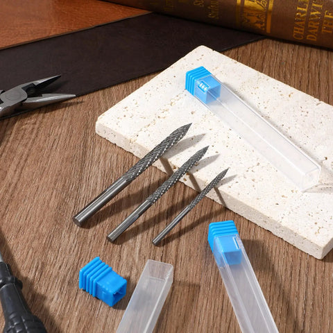 A Tough As Nails Three Piece Tire Reamer Drill Bit Set Featuring Sharp Carbide Burrs for flat tire repairs on a wooden surface.