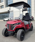 Top Shelf Two Seater Electric Golf Cart Equipped With A Dependable 48V Lithium Battery And Punchy Lightweight Frame For Sweet All Terrain Cruising In Fiery Red, viewed from the front with clear windshield.