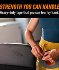 Person using Heavy Duty Black Duct Tape 1.88 Inch By 50 Yard Indoor Outdoor Weather Resistant With Reinforced Backing And Double Thick Adhesive.