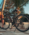 Side view of EB5 1000W Peak Brushless Motor Dope Electric Bike with palm trees, showcasing 26-inch tires and 500Wh removable battery.