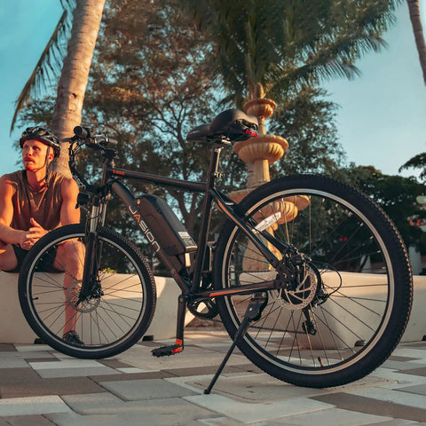Side view of EB5 1000W Peak Brushless Motor Dope Electric Bike with palm trees, showcasing 26-inch tires and 500Wh removable battery.