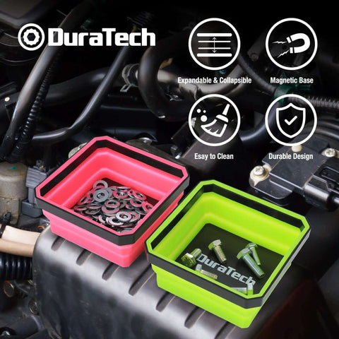 Two collapsible silicone tool trays with double-sided magnetic base holding screws and washers on a car engine