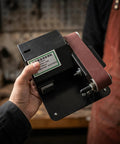 Compact Mini Electric Belt Sander With A Kickass Motor For Handheld Wood Sanding And Fast Metal Polishing Quick Rust Removal And Smooth DIY Finishes Built Like A Rock Solid Workhorse held in hand.