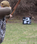 Archer aiming at Two-Sided High Velocity Archery Bag Target For Practice Up To 425 FPS Compact 28x28x12 Inch