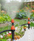 25 Adjustable Drip Irrigation Emitters For Quarter Inch Hose 360 Degree Water Flow Stake Drippers in a garden bed