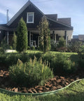 4 Inch HDPE Landscape Edging For Lawns And Flower Beds Flexible Garden Border System Black Easy To Install In Straight Lines Or 90 Degree Turns Frost And Rain Resistant surrounding a flower bed in front of a house