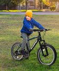 Child riding Kids Mountain Bike 20 Inch With 7 Speed Drivetrain, Front Suspension Fork and Disc Brakes in park setting