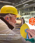 Worker wearing vented hard shell bump cap with suspension for lightweight head protection in construction site setting.