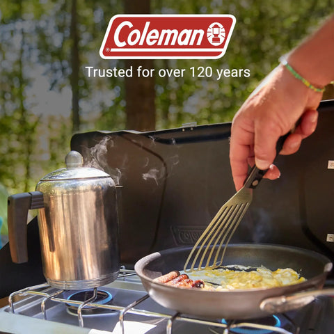 Cooking breakfast on Two-Burner Propane Camp Stove With InstaStart Ignition And Wind Guards, showing eggs and sausages frying.