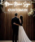 Couple in front of "Neon Name Sign Customize" display for Personalized Neon Sign For Weddings And Events Dope Custom LED Light Sign.