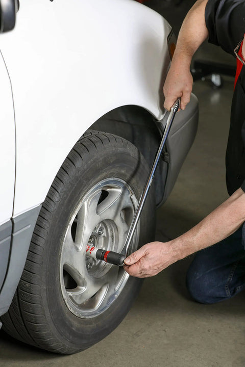 Person using Three Eighths Inch Drive Ratcheting Breaker Bar, 15 Inch Length, 24 Tooth Ratchet, Heavy Duty Chrome Vanadium on car tire.