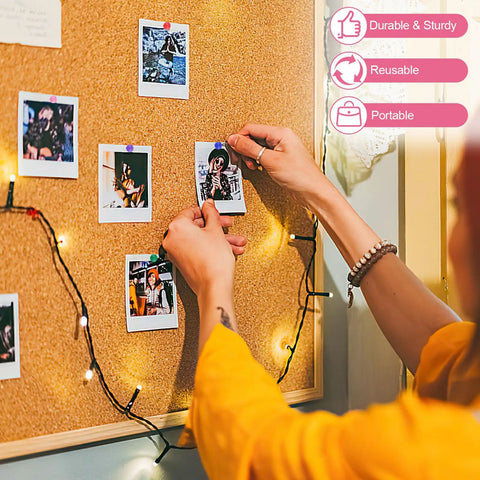 Person using Total Game Changer 1000 Piece Assorted Color Map Push Pins on bulletin board with photos.