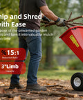 Heavy Duty Wood Chipper Shredder Mulcher With 7HP 212cc Gas Power, turning branches into mulch, manual operation shown