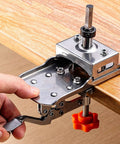 Montesy 35mm stainless hinge boring jig clamped to wood edge with orange knob drilling guide