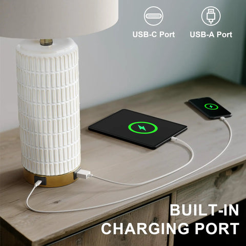 Set Of 2 Ceramic Table Lamps 24 Inch For Nightstands And Living Rooms Farmhouse Chic Modern Style White Finish Bedroom Bedside End Tables Ambient Lighting With Soft Glow featuring USB ports charging devices on a table.