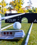 All In One Golf Training Tool With 11 In 1 Alignment Sticks And Swing Plane System on grass with putter and golf ball
