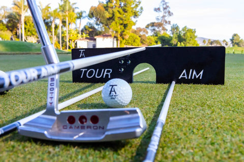 All In One Golf Training Tool With 11 In 1 Alignment Sticks And Swing Plane System on grass with putter and golf ball