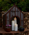 Outdoor Slim Pillar Flameless Led Candles Set Of 3 Ivory With Moving Flame Weather Resistant Remote Timer Ready Battery Operated Safe Melted Edge No Fuss Low Maintenance Glow For Porch Or Patio displayed in a mini greenhouse setting.