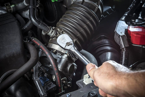Mechanic using Three Eighths Inch Drive 84 Tooth Teardrop Ratchet With Long 11 Inch Handle Built For Tight Spaces in engine bay